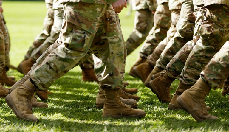 U.S. Army soldiers wear boots as they march in formation.