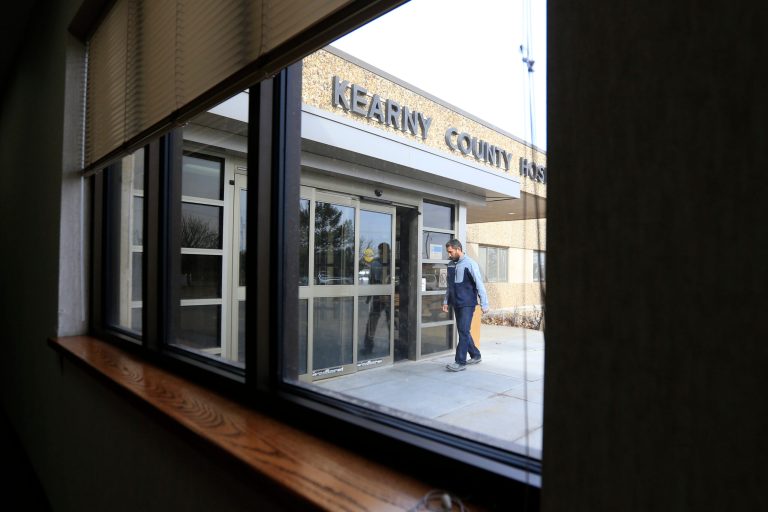 A visitor enters Kearny County Hospital in Lakin, Kan.