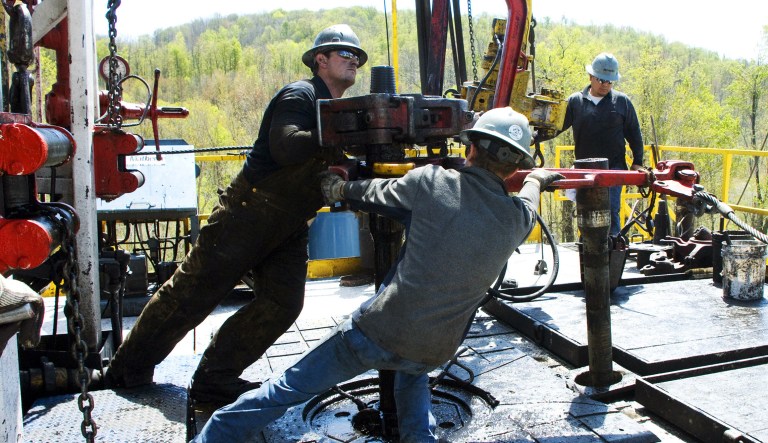 In this April 23, 2010, file photo, workers move a section of well casing into place at a Chesapeake Energy natural gas well site near Burlington, Pa., in Bradford County.