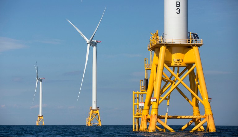 In this Monday, Aug. 15, 2016 file photo three of Deepwater Wind's turbines stand in the water off Block Island, R.I. 