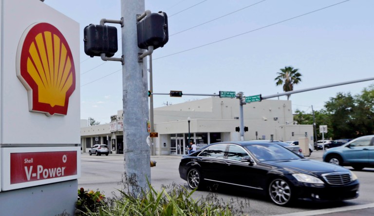 Motorists pass by a Shell sign in Miami. 