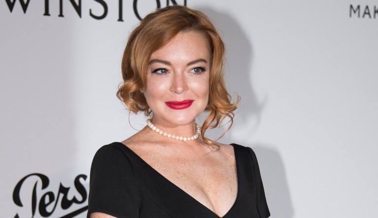 Lindsay Lohan poses for photographers upon arrival at the amfAR charity gala during the Cannes 70th international film festival.