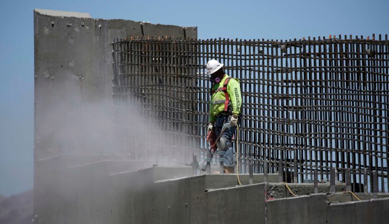 In this May 19, 2017, photo, a man works on the Southern Nevada portion of U.S. Interstate 11 near Boulder City, Nev.