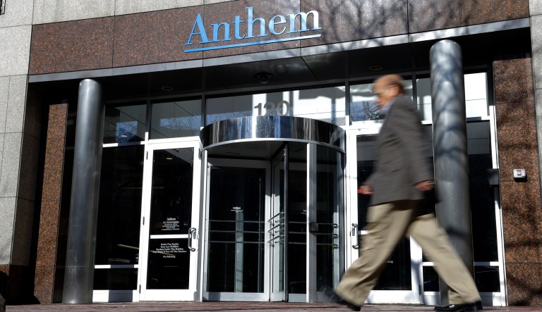 FILE - In this Thursday, Feb. 5, 2015, file photo, a man walks past health insurer Anthem's corporate headquarters in Indianapolis. Anthem, one of the nationâs biggest health insurers, says it will not return to Ohioâs public insurance exchanges in 2018, a decision that could open more holes in the Affordable Care Actâs increasingly thin system for helping people buy coverage.
