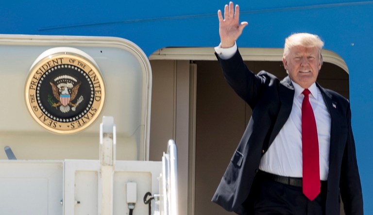 President Donald Trump waves as he arrives on Air Force One at General Mitchell International Airport in Milwaukee, Wis., Tuesday, June 13, 2017.