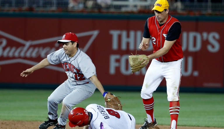 Rep. Raul Ruiz, D-Calif., left, tags out Rep. Mike Bishop, R-Mich., on the steal attempt with Rep. Tim Ryan, D-Ohio, at right, during the 2017 congressional baseball game in Washington. 
