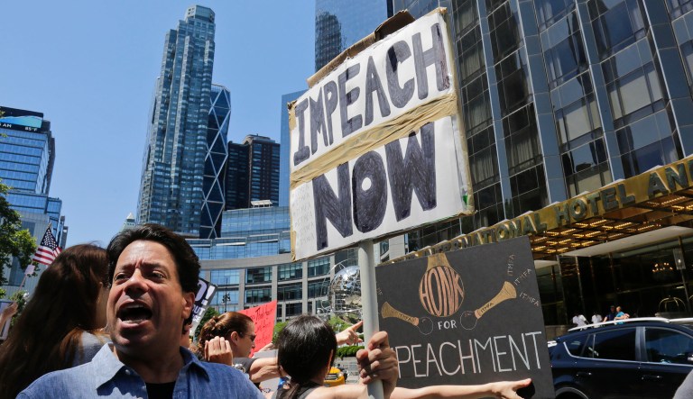 Protesters rally outside a Trump hotel to call for the impeachment of President Trump in New York.