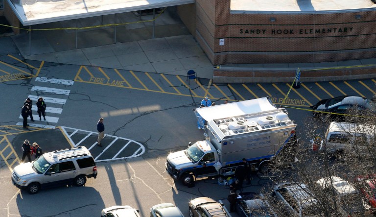 In this Dec. 14, 2012 aerial file photo, officials stand outside of Sandy Hook Elementary School in Newtown, Conn.