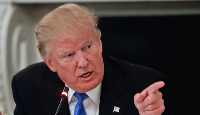 President Donald Trump points towards GOP Senators during their luncheon, Wednesday, July 19, 2017, in the State Dinning Room of the White House in Washington.