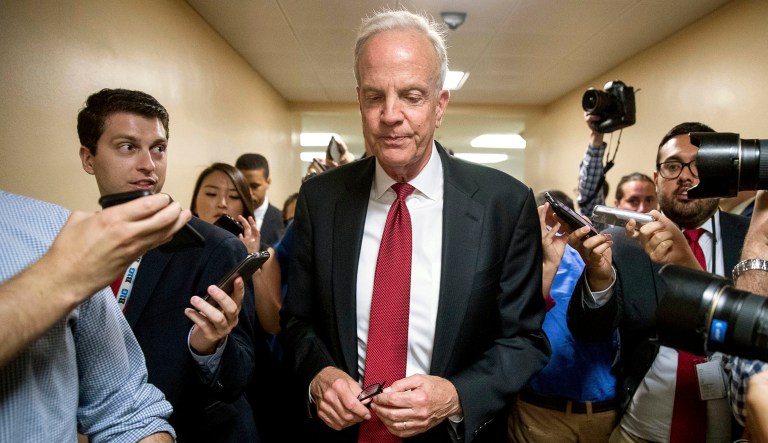 Sen. Jerry Moran, R-Kan. is pursued by reporters as he arrives on Capitol Hill in Washington.
