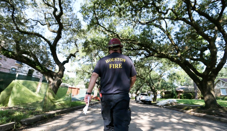 A Houston firefighter walks through town.