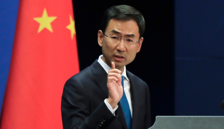 Chinese Foreign Ministry spokesman Geng Shuang gestures as he speaks during a daily briefing at the Ministry of Foreign Affairs office in Beijing.