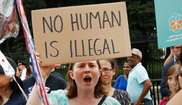 Laurel Hoa, of Kensington, Md., center, holds up a sign that says "no human is illegal," with her son Gabe Hoa, 3, during a rally in support of the Deferred Action for Childhood Arrivals program known as DACA, outside of the White House, in Washington, Tuesday, Sept. 5, 2017. President Donald Trump's administration will "wind down" a program protecting hundreds of thousands of young immigrants who were brought into the country illegally as children, Attorney General Jeff Sessions declared Tuesday, calling the Obama administration's program "an unconstitutional exercise of authority."