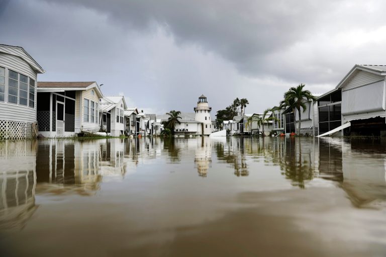 In this 2017 photo, a mobile home community is flooded in the aftermath of Hurricane Irma in Everglades City, Fla.