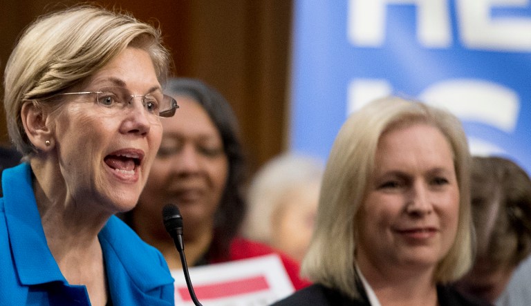 Sen. Elizabeth Warren, D-Mass., center, accompanied by Sen. Kirsten Gillibrand, D-N.Y., right, speaks during a news conference on Capitol Hill in Washington, Wednesday, Sept. 13, 2017.