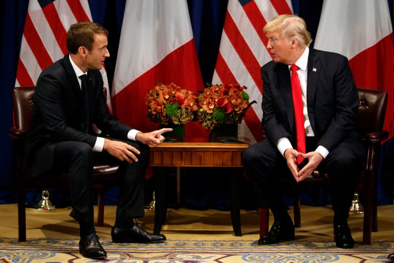 President Trump speaks with French President Emmanuel Macron (pictured left) at a meeting.