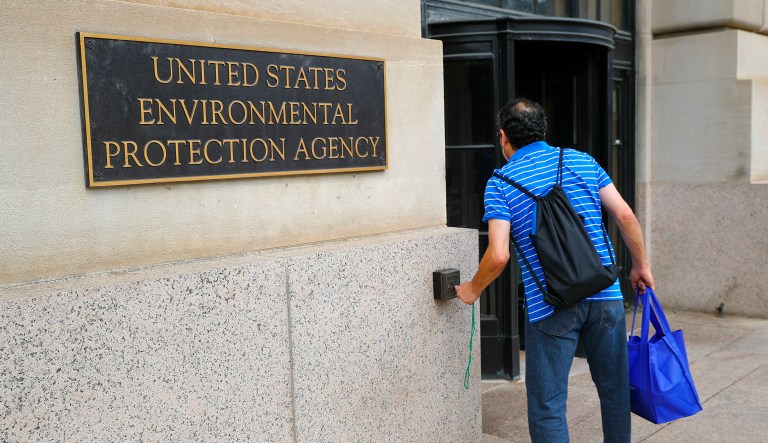 A man uses his badge to open the door at the Environmental Protection Agency (EPA) Building in Washington.