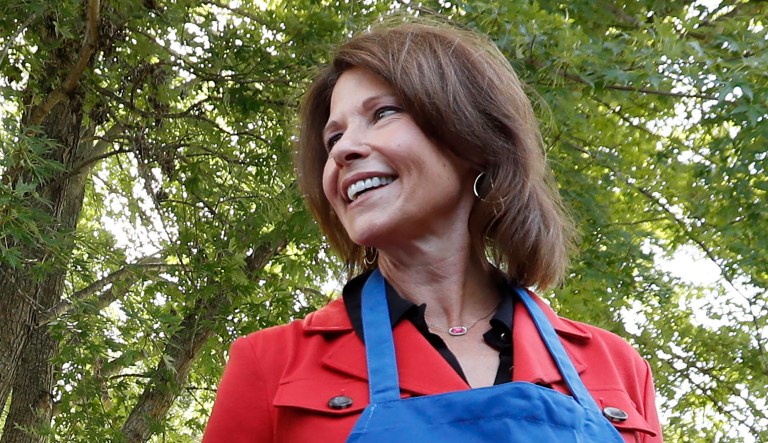 Rep. Cheri Bustos, D-Ill., flips burgers during the Polk County Democrats Steak Fry, Saturday, Sept. 30, 2017, in Des Moines, Iowa.
