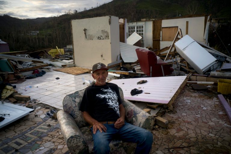 CORRECTS FROM MORAVIS TO MOROVIS- Luis Cosme poses sitting in an armchair in what is left of his house destroyed by Hurricane Maria, in Morovis, Puerto Rico, Sunday, Oct. 1, 2017. Cosme, a worker at a cleaning company, felt the high winds  and ran to the shelter at the Catholic church building. In the morning he came out and saw his house gone. "Thank God I am alive" he said.