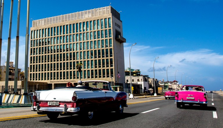 In this 2017 photo, tourists ride classic convertible cars on the Malecon beside the U.S. Embassy in Havana, Cuba. 
