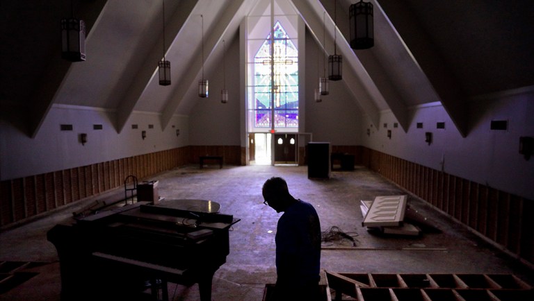 Wayne Christopher walks through the Hurricane Harvey-damaged sanctuary of the Memorial Baptist Church in Port Arthur, Texas.