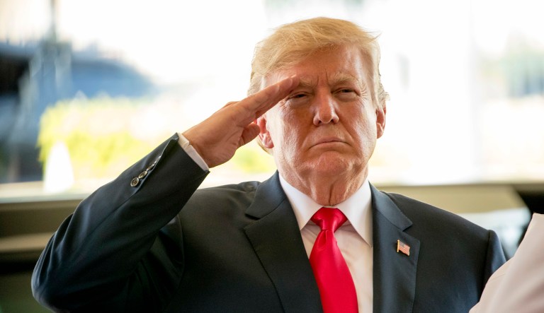 President Trump salutes during an event.