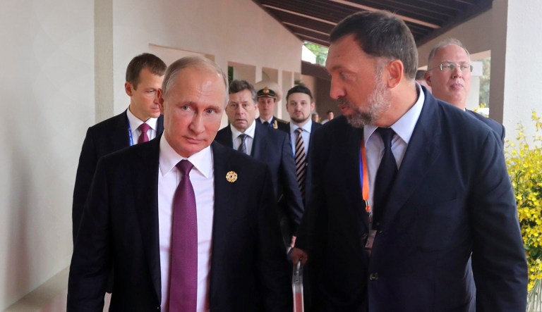 Russia's President Vladimir Putin, left, and Russian metals magnate Oleg Deripaska, right, walk to attend the APEC Business Advisory Council dialogue in Danang, Vietnam, Friday, Nov. 10, 2017.