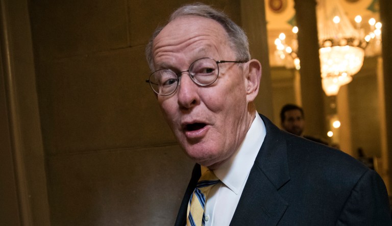 Sen. Lamar Alexander, R-Tenn., speaks to a reporter in the Capitol on Dec. 1, 2017.