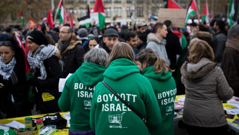 Demonstrators wear shirts reading "Boycott Israel" during a protest against President Trump's decision to recognize Jerusalem.
