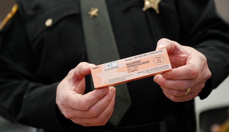 Capt. Paul Kamphaus of the Clermont County Sheriff's Office handles a box of naloxone during a 2017 interview in Batavia, Ohio.