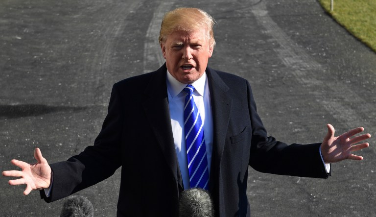 Donald Trump talks with reports as he departs from the South Lawn of the White House.