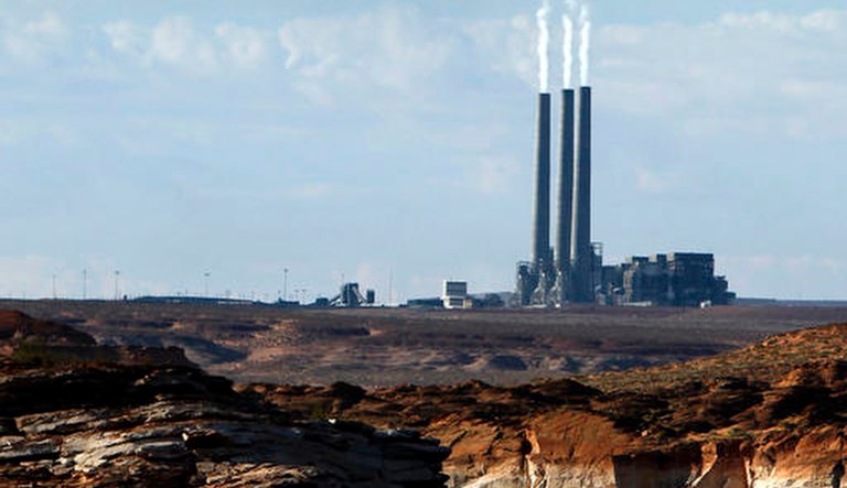 Smoke rises from the stacks of the main coal plant facility at the Navajo Generating Station in Page, Ariz. The owners of a massive coal-fired power plant on the Navajo Nation voted in February to shut the facility down in 2019 because cheaper power is available from other sources in a decision that could hurt the Navajo and Hopi tribes and cost hundreds of jobs.