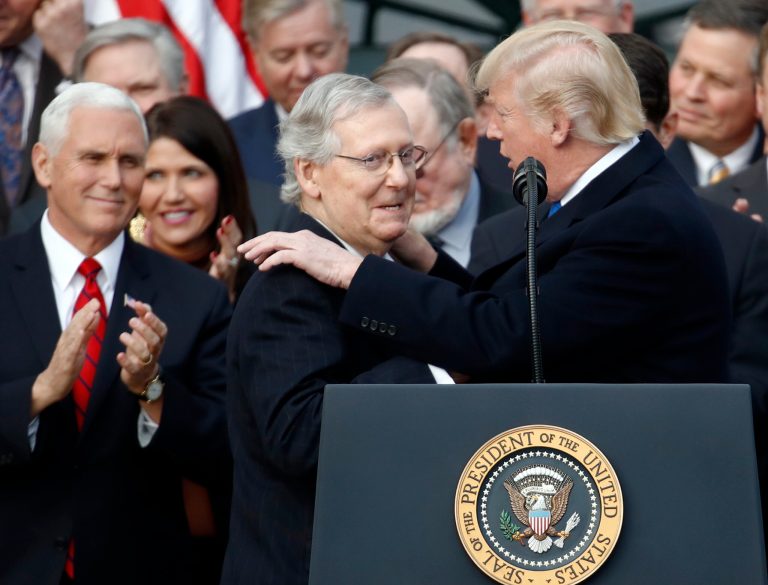President Donald Trump introduces Senate Majority Leader Sen. Mitch McConnell of Ky., during a bill passage event on the South Lawn of the White House in Washington, Wednesday, Dec. 20, 2017, to acknowledge the final passage of tax cut legislation by Congress.