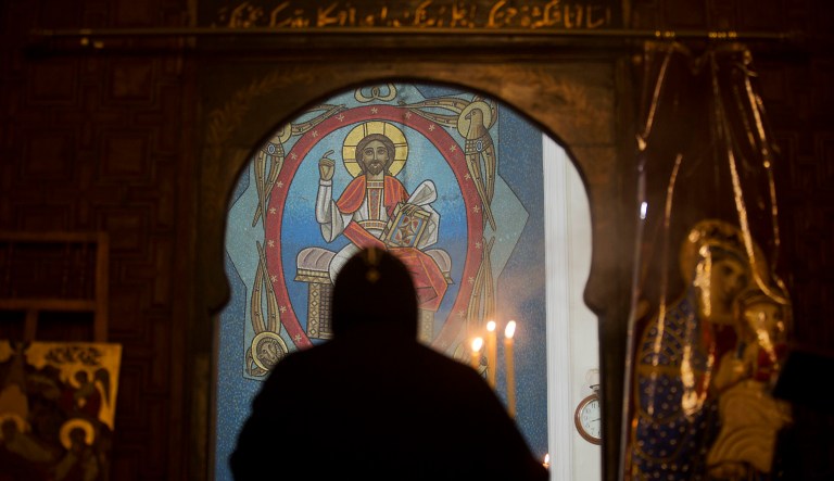 A priest leads prayers at Virgin Mary church, in Cairo, Egypt. 