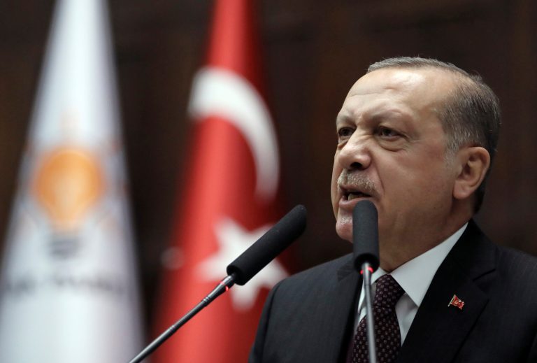 Turkey's President and leader of ruling Justice and Development Party Recep Tayyip Erdogan addresses his supporters and lawmakers at the parliament in Ankara, Turkey, Tuesday, Jan. 9, 2018. 