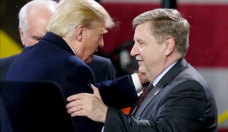 President Donald Trump, left, greets Rick Saccone after speaking in Coraopolis, Pa.
