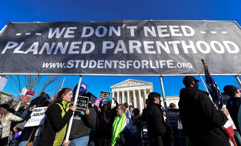 People participate in the March for Life near the Supreme Court in Washington, Friday, Jan. 19, 2018.