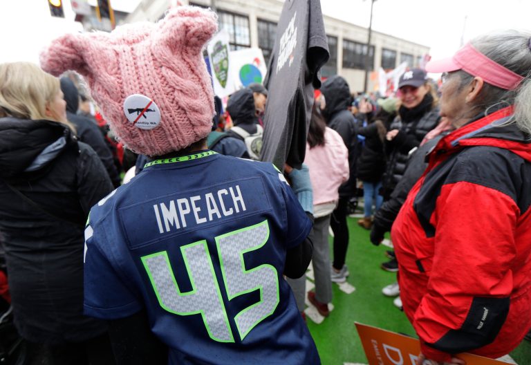 Democratic voters, like these in a Women's March in Seattle in January, want impeachment proceedings against President Truump. House leaders are looking at five other probes if they take charge in the midterm elections.