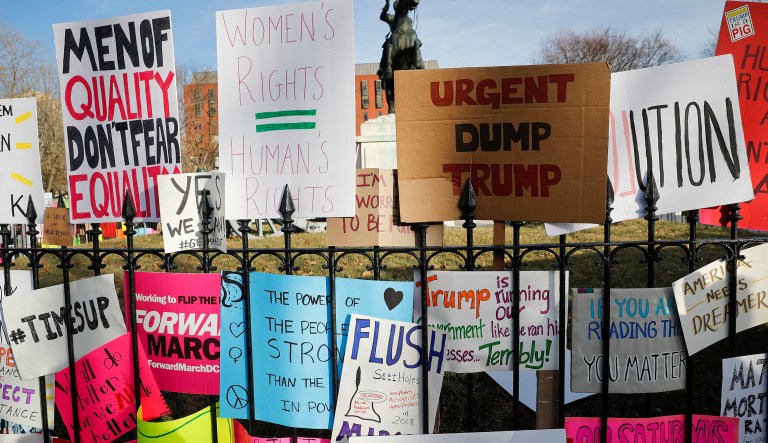 Signs are left at the base of statue of President Andrew Jackson in Lafayette Park, across the street from the White House in Washington, near the end of the Women's March demonstrators, Saturday, Jan. 20, 2018. On the anniversary of President Donald Trump's inauguration, people participating in rallies and marches in the U.S. and around the world Saturday denounced his views on immigration, abortion, LGBT rights, women's rights and more.
