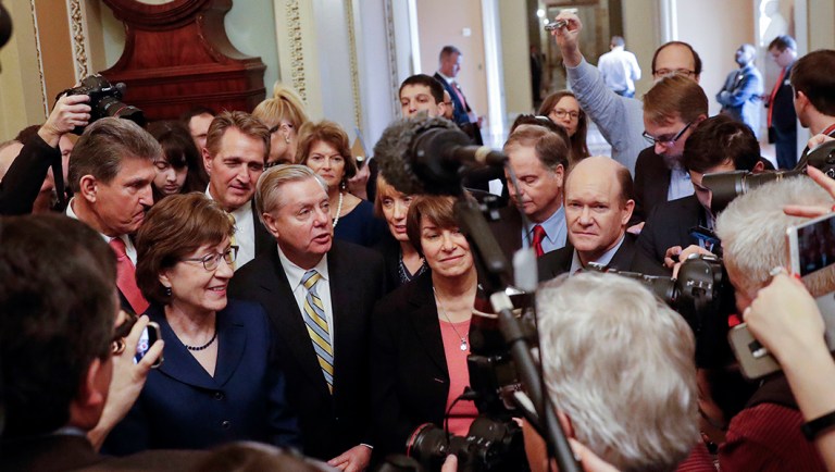 Sen. Lindsey Graham, R-S.C., center, speaks to members of the media outside the Senate Chamber on Capitol Hill.
