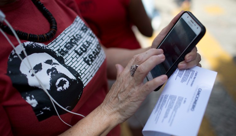 A supporter uses her cellphone during a protest.