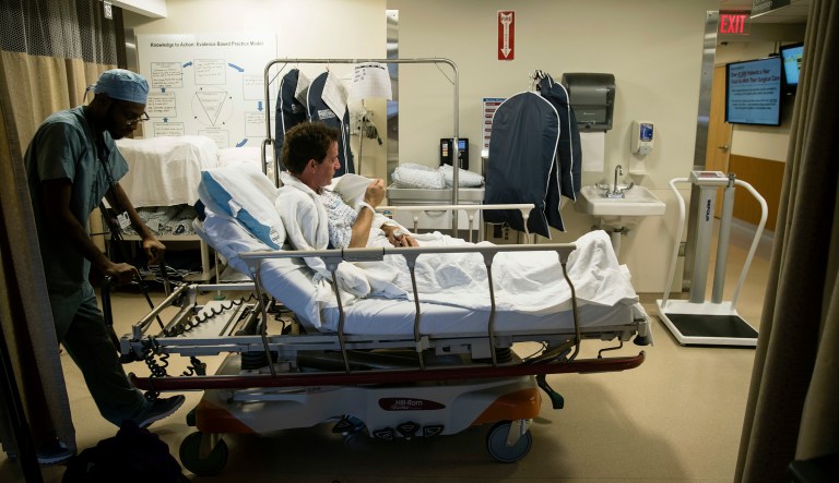 Ryan Ciccozzi (pictured seated, center) is taken to surgery at the Hospital of the University of Pennsylvania in Philadelphia.