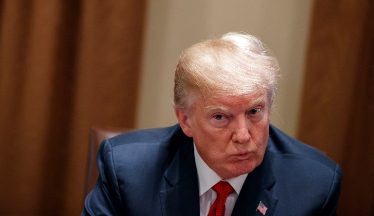 President  Trump listens during a meeting with law enforcement officials on the MS-13 street gang and border security.