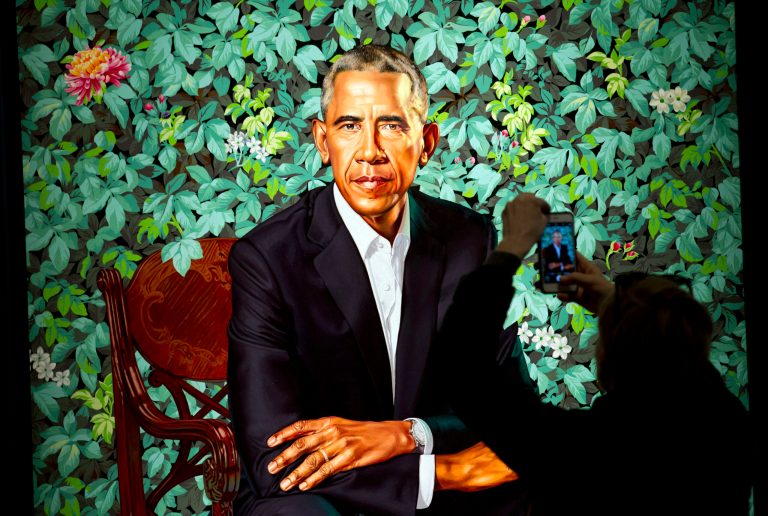 A visitors take picture of the official portrait of the former President Barack Obama in the first day open exhibit at the Smithsonian's National Portrait Gallery, Tuesday, Feb. 13, 2018, in Washington. Barack Obama's portrait was painted by artist Kehinde Wiley, and Michelle Obama's portrait was painted by artist Amy Sherald.