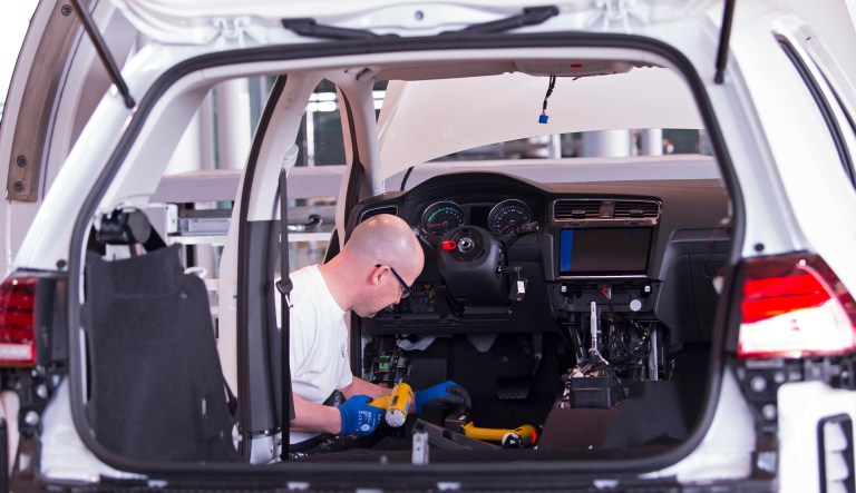 Detlef Schwantke assembles an e-Golf electric car during the official production expansion in the German car manufacturer Volkswagen Transparent Factory  in Dresden, Germany, Monday, March 5, 2018.