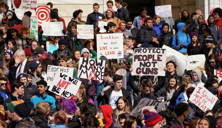 Thousands of high school students hold a rally after they walked out of their schools and marched to the state Capitol in Saint Paul, Minn.