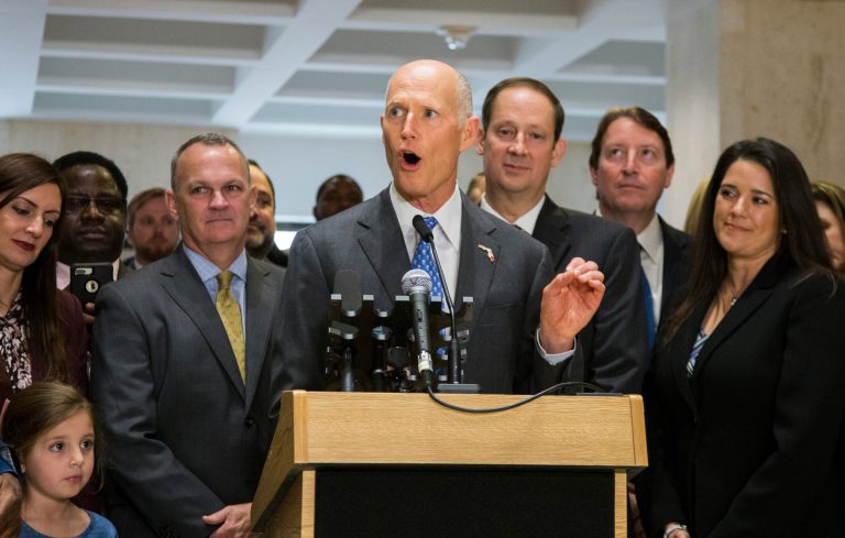 Florida Gov. Rick Scott speaks after the end of the legislative session at the Florida State Capitol in Tallahassee, Fla., Sunday, March 11, 2018. Flanking Scott is Speaker of the House Richard Corcoran, left, and Senate President Joe Negron.