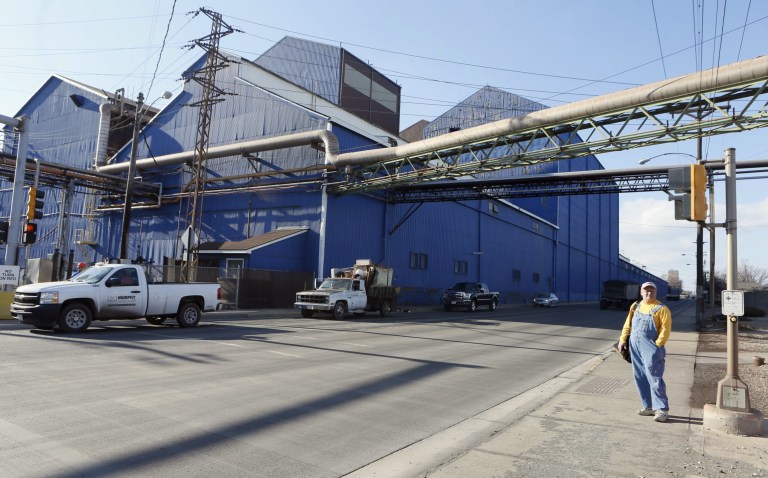 In this 2015 file photo, a worker stands outside the U.S. Steel Corp. coke plant, part of the company's complex in Granite City, Ill.