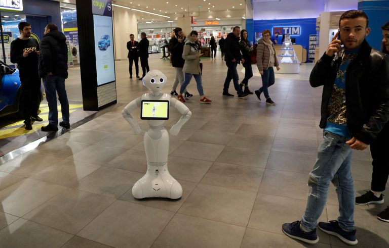 Robot Cayuiki stands by a car dealership, in Brescia, northern Italy, Monday, March 12, 2018. The robot has been programmed to give information on cars, play games, and gather client personal information for call-backs, its gee-whiz presence helping to create interest in passers-by who otherwise might walk right past a parked car.