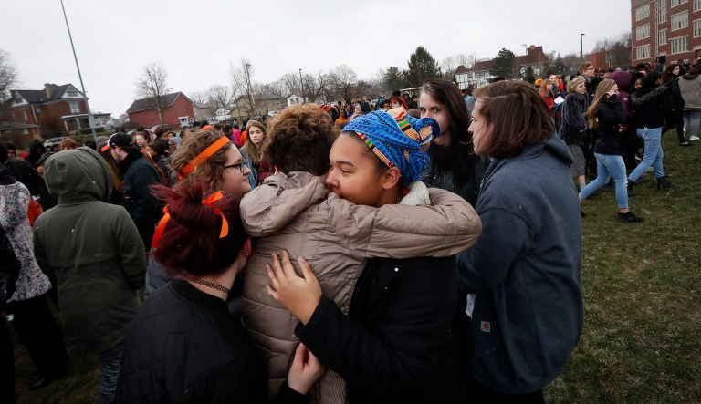 Students embrace as they gather on their soccer field during a 17-minute walkout protest at the Stivers School for the Arts, Wednesday, in Dayton, Ohio. Students across the country participated in walkouts Wednesday to protest gun violence, one month after the deadly shooting inside a high school in Parkland, Fla.